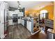 Open-concept kitchen featuring stainless appliances, white cabinets, and a view into the dining area at 5982 Blue Heron Way, Plainfield, IN 46168