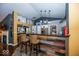 Open kitchen and bar area with two stools and an eye-catching stone countertop at 5982 Blue Heron Way, Plainfield, IN 46168