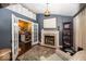 Cozy living room featuring a fireplace, hardwood floors, and an open doorway to the kitchen at 5982 Blue Heron Way, Plainfield, IN 46168