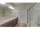 Bathroom with double sinks, shower, and granite countertops at 6118 Aspen Meadow Dr, Indianapolis, IN 46237