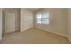 A carpeted bedroom with a window and a closet at 6118 Aspen Meadow Dr, Indianapolis, IN 46237