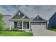 Charming single-story home with a well-manicured lawn and a two-car attached garage, exuding curb appeal at 6118 Aspen Meadow Dr, Indianapolis, IN 46237