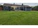 Expansive backyard featuring a covered patio, lush green lawn, and privacy fence at 628 Williams Ct, Greenwood, IN 46142