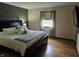 Relaxing bedroom with a king bed, wood floors, and natural light from the window at 628 Williams Ct, Greenwood, IN 46142