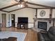 Open living room with hardwood floors, a brick fireplace, and a flat-screen TV at 628 Williams Ct, Greenwood, IN 46142