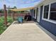 Back patio with outdoor seating, sunshade, and grill is perfect for entertaining guests at 628 Williams Ct, Greenwood, IN 46142