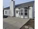 This backyard features a concrete patio, a grey roof and siding, and a small fenced yard at 6431 Furnas Rd, Indianapolis, IN 46221