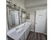 Bathroom featuring a double sink vanity, a framed mirror and a separate door to the toilet and shower at 6431 Furnas Rd, Indianapolis, IN 46221
