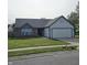 Well maintained single-story home featuring brick accents, a paved driveway and a two car garage at 6431 Furnas Rd, Indianapolis, IN 46221
