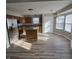 A large stainless steel refrigerator enhances this eat-in kitchen with a center island and laminate floors at 6431 Furnas Rd, Indianapolis, IN 46221