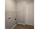 Bright laundry room with wood-look floors, utility connections and a closet for extra storage at 6431 Furnas Rd, Indianapolis, IN 46221