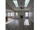 Open-concept living room with a fireplace, updated flooring, vaulted ceilings and lots of natural light at 6431 Furnas Rd, Indianapolis, IN 46221