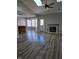 Open living room boasts a fireplace, ceiling fan, and hardwood floors, perfect for entertaining and relaxation at 6431 Furnas Rd, Indianapolis, IN 46221