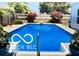This backyard features an inground swimming pool with mature trees and privacy fence at 6431 Furnas Rd, Indianapolis, IN 46221