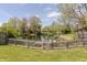 Scenic backyard pond with wooden dock, bordered by mature trees and lush greenery, creating a tranquil outdoor retreat at 6602 Cobden Ct, Indianapolis, IN 46254