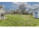 Large backyard with a pond view beyond the wooden fence, featuring a storage shed and ample green space at 6602 Cobden Ct, Indianapolis, IN 46254