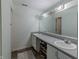 Bright bathroom with double sinks, a large mirror, and plenty of storage space at 6602 Cobden Ct, Indianapolis, IN 46254