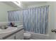 Bathroom featuring modern vanity, full shower and tub, and patterned curtain at 6602 Cobden Ct, Indianapolis, IN 46254