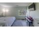 Bright bedroom with a large window, tv, modern furniture and a gray patterned rug at 6602 Cobden Ct, Indianapolis, IN 46254