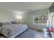 Comfortable bedroom with a queen-sized bed, a soft rug, and a view of the fenced backyard at 6602 Cobden Ct, Indianapolis, IN 46254