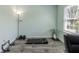 Well-lit bedroom featuring exercise equipment and home office, and laminate wood flooring at 6602 Cobden Ct, Indianapolis, IN 46254