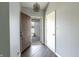 Welcoming entryway with a modern light fixture, hardwood floors, and a view to the front porch at 6602 Cobden Ct, Indianapolis, IN 46254
