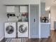 Laundry area with updated appliances, gray storage cabinets, and convenient access to the kitchen at 6602 Cobden Ct, Indianapolis, IN 46254