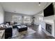 Open concept living room with hardwood floors, fireplace, large windows, and abundant natural light at 6602 Cobden Ct, Indianapolis, IN 46254