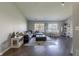 Open concept living room with hardwood floors, fireplace, large windows, and abundant natural light at 6602 Cobden Ct, Indianapolis, IN 46254