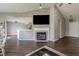 Living room with fireplace, vaulted ceiling, hardwood floors, and open concept to the kitchen at 6602 Cobden Ct, Indianapolis, IN 46254
