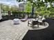 Well manicured backyard with stone patio, featuring outdoor seating, lounge chairs and black mulch at 6655 Westminster Dr, Zionsville, IN 46077