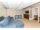 Finished basement with a blue couch, built in shelving, and a TV for entertainment at 6655 Westminster Dr, Zionsville, IN 46077