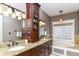 Elegant bathroom with double sinks, granite countertops, and a soaking tub at 6655 Westminster Dr, Zionsville, IN 46077