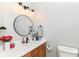 Modern bathroom with a sleek vanity, round mirror, and updated fixtures at 6655 Westminster Dr, Zionsville, IN 46077