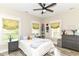 Bright, charming bedroom with floral curtains, plenty of natural light and cozy decor elements at 6655 Westminster Dr, Zionsville, IN 46077