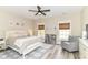 Charming bedroom featuring a ceiling fan, two windows, and beautiful decor at 6655 Westminster Dr, Zionsville, IN 46077