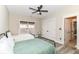 Bright bedroom with twin beds, a ceiling fan, and a large window bringing in lots of natural light at 6655 Westminster Dr, Zionsville, IN 46077