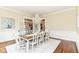 Elegant dining room with a classic chandelier, wainscoting and a beautiful wood table at 6655 Westminster Dr, Zionsville, IN 46077