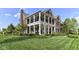 Stately two-story brick home with large columns and manicured lawn showcasing its curb appeal at 6655 Westminster Dr, Zionsville, IN 46077