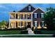 Stunning two-story brick home with a covered front porch, white columns, and manicured lawn at 6655 Westminster Dr, Zionsville, IN 46077