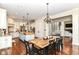 Spacious kitchen with hardwood floors, an island, and an open dining area at 6655 Westminster Dr, Zionsville, IN 46077