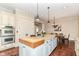 Bright kitchen featuring an island, a dining area, hardwood floors, and stainless steel appliances at 6655 Westminster Dr, Zionsville, IN 46077
