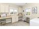 Well-lit laundry room featuring a sink, counter space, and ample storage at 6655 Westminster Dr, Zionsville, IN 46077