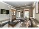 Cozy living room with a leather sofa, fireplace, and natural light at 6655 Westminster Dr, Zionsville, IN 46077