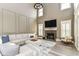 Sunlit living room with high ceilings, a fireplace, and a comfortable seating arrangement at 6655 Westminster Dr, Zionsville, IN 46077