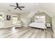 Bright main bedroom features a ceiling fan, light walls, and hardwood floors at 6655 Westminster Dr, Zionsville, IN 46077