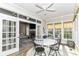 Inviting sunroom with large windows, tile flooring, and access to an outdoor living space at 6655 Westminster Dr, Zionsville, IN 46077