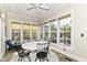 Bright sunroom with multiple windows, a ceiling fan, and cozy seating at 6655 Westminster Dr, Zionsville, IN 46077