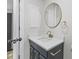 Stylish bathroom featuring a modern vanity with gold fixtures and a round mirror at 729 S Holmes Ave, Indianapolis, IN 46221
