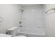 A bright bathroom with white tub, shower, and toilet, with gold hardware at 729 S Holmes Ave, Indianapolis, IN 46221